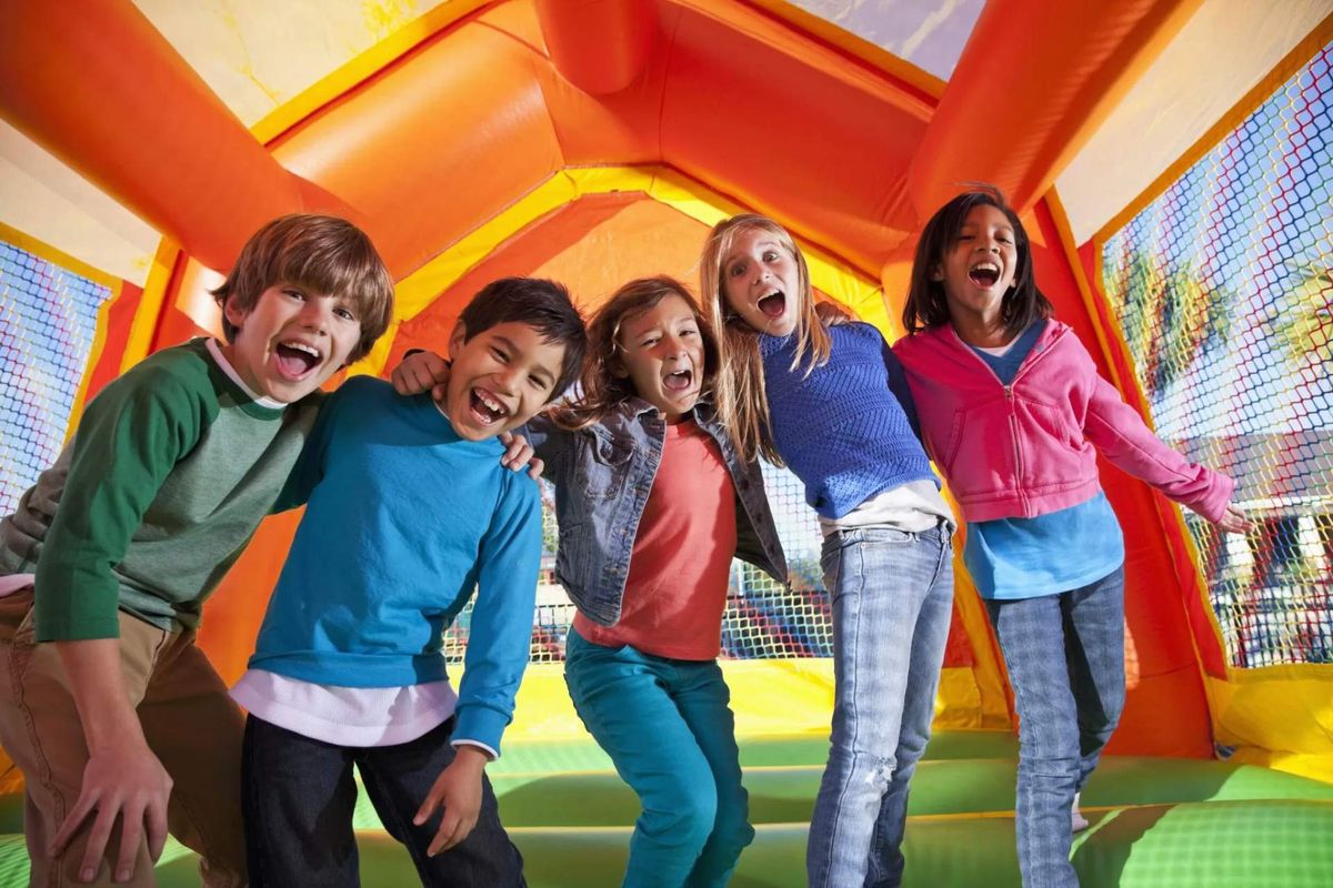 Colorful bounce houses set up at a kids' party